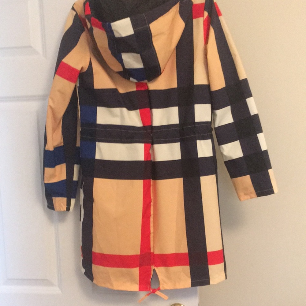 Multi colored rain coat 30 in long. 2 side pockets and attached hood.